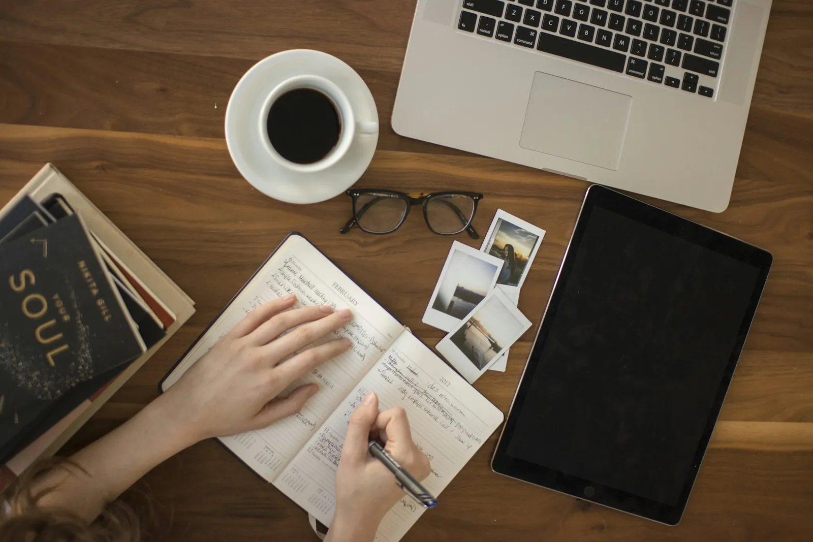 Planning an audiobook project at a desk with a notebook, laptop and coffee